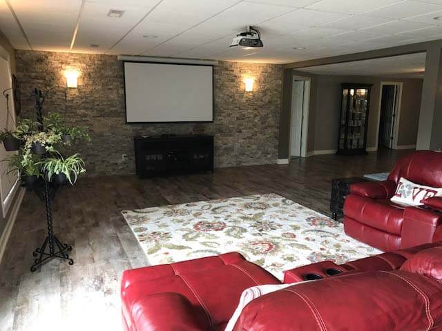 Basement Remodel with stone feature wall and flooring