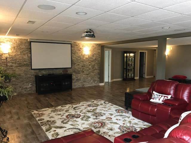 Basement Remodel with stone feature wall and flooring