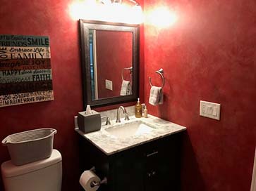 half bath with painted walls and granite countertop