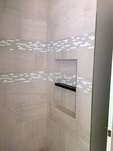 Marble shower with shampoo shelf