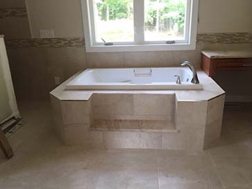 Jacuzzi tub with marble platform and built-in step