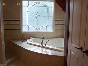 jacuzzi tub with tile feature wall